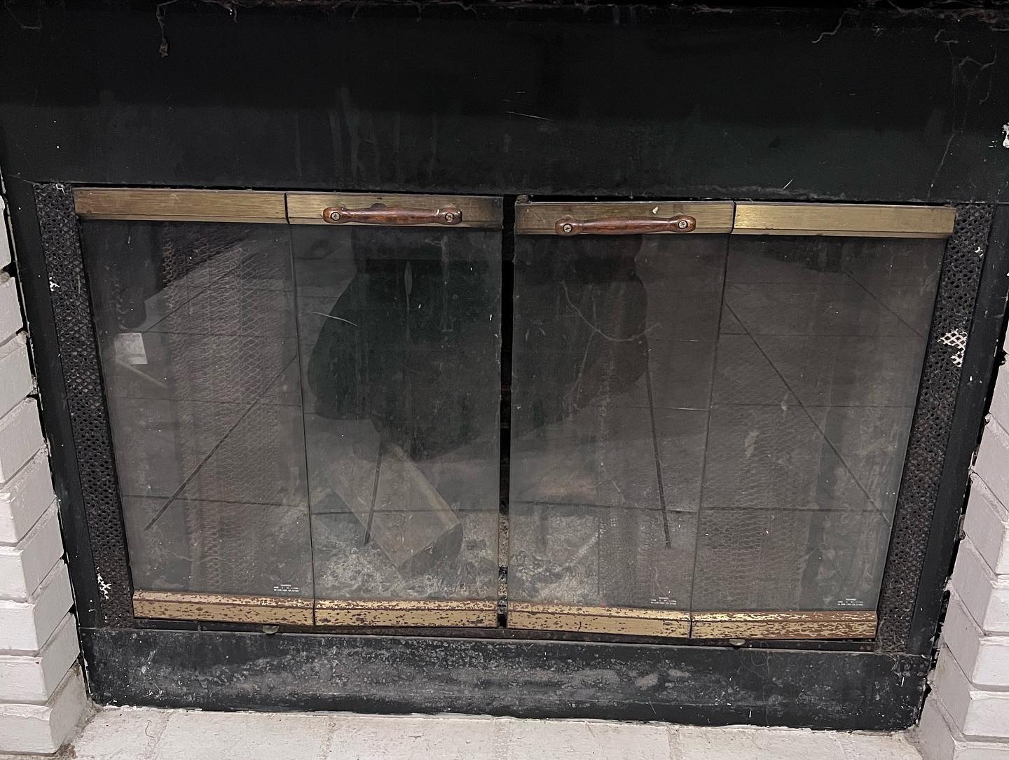 Fireplace with glass doors and a black surround